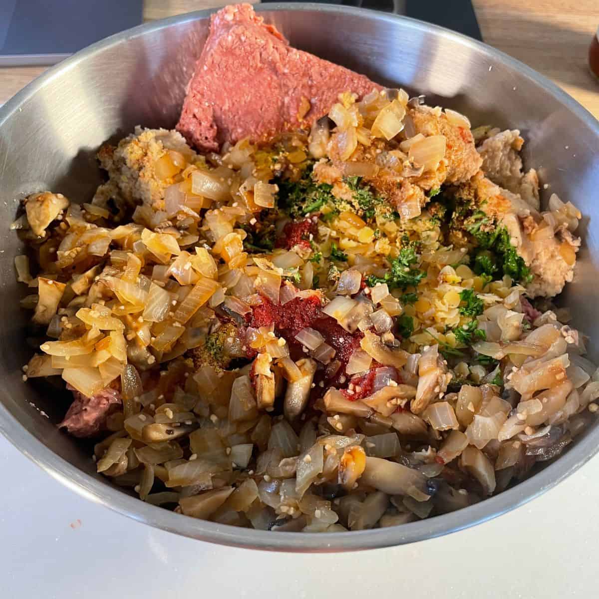 all ingredients are combined in a bowl to make the vegan meatloaf 