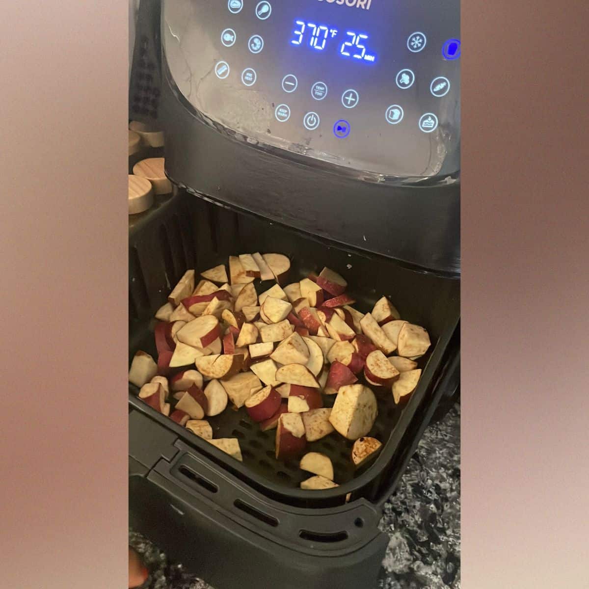 Cube of Japanese white sweet potatoes in the air fryer drawer ready to be roasted