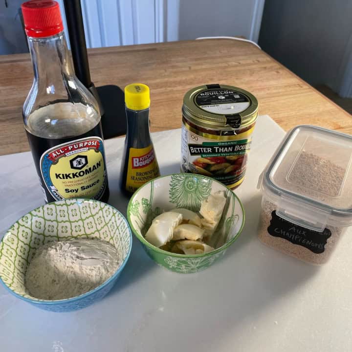 ingredients put on the table to make the gluten free vegan gravy: soya sauce, kitchen bouquet, better than bouillon, vegan butter, gluten free flour and mushroom seasoning