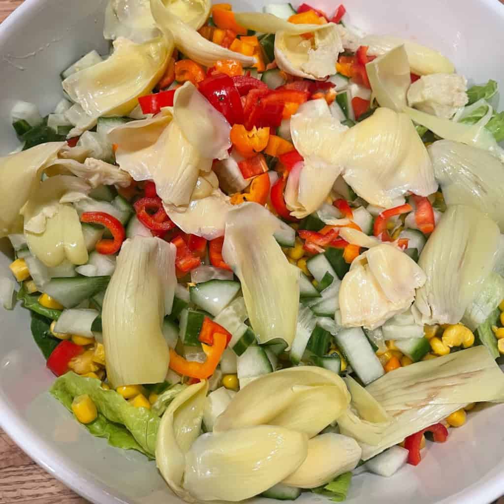 A colorful plant-based fresh salad featuring mixed greens, vegetables, and light seasoning for a wholesome meal.