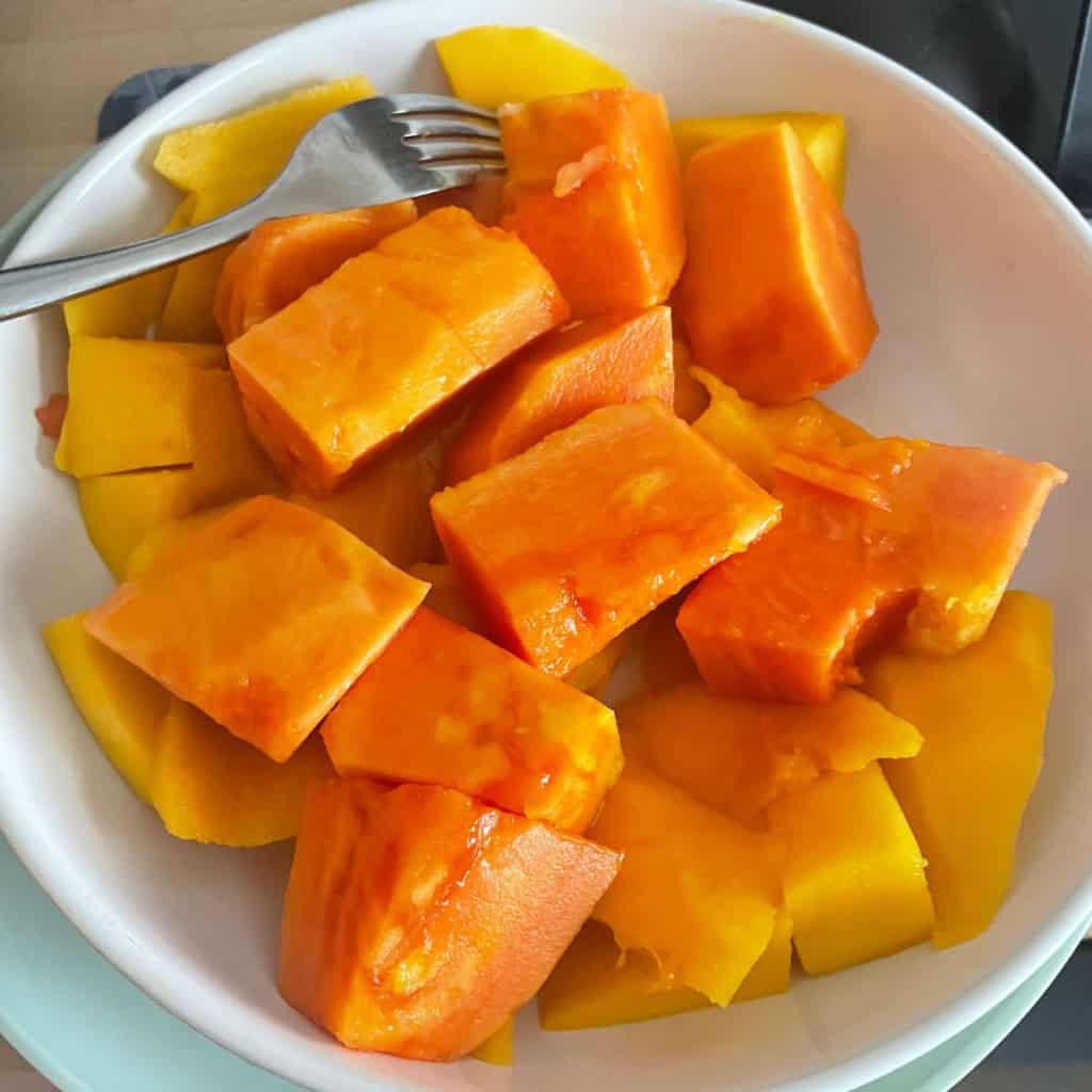 Freshly cut butternut squash and sweet potatoes in a white bowl for healthy eating.